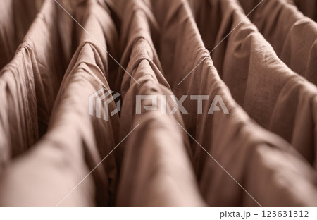 Abstract close up of brown textured fabric with pleats and folds in soft Abstract close up of brown textured fabric with pleats and folds in soft 123631312