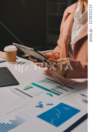 Cropped image of professional businesswoman working at her office via laptop, young female manager using portable computer device while sitting at modern loft, flare light, work process concept Cropped image of professional businesswoman working at her office via laptop, young female manager using portable computer device while sitting at modern loft, flare light, work process concept 123632213