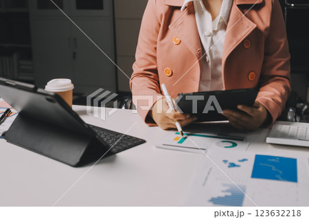Cropped image of professional businesswoman working at her office via laptop, young female manager using portable computer device while sitting at modern loft, flare light, work process concept Cropped image of professional businesswoman working at her office via laptop, young female manager using portable computer device while sitting at modern loft, flare light, work process concept 123632218
