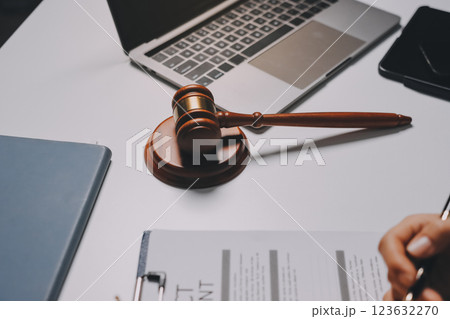 Judge gavel with Justice lawyers having team meeting at law firm background. Concepts of Law and Legal services. 123632270