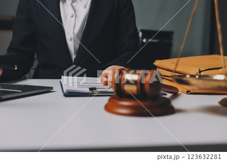 Judge gavel with Justice lawyers having team meeting at law firm background. Concepts of Law and Legal services. 123632281