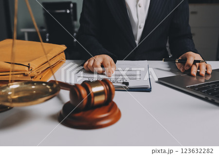 Judge gavel with Justice lawyers having team meeting at law firm background. Concepts of Law and Legal services. 123632282