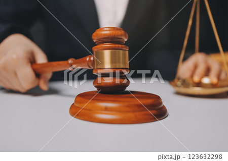 Judge gavel with Justice lawyers having team meeting at law firm background. Concepts of Law and Legal services. 123632298