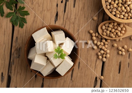 Sliced block tofu,Hard white Tofu soy bean curd in wooden bowl.Top view. Sliced block tofu,Hard white Tofu soy bean curd in wooden bowl.Top view. 123632650