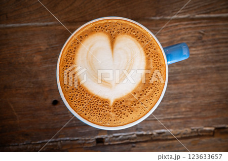 A hot Cappuccino coffee serving on wooden table. A hot Cappuccino coffee serving on wooden table. 123633657