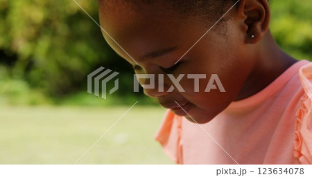 Close up of little girl using a tablet computer in a park 123634078