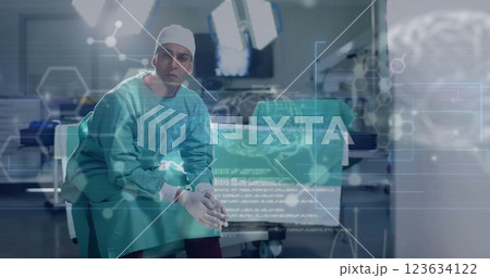Image of data processing with molecules and brains over caucasian male surgeon in hospital Image of data processing with molecules and brains over caucasian male surgeon in hospital 123634122