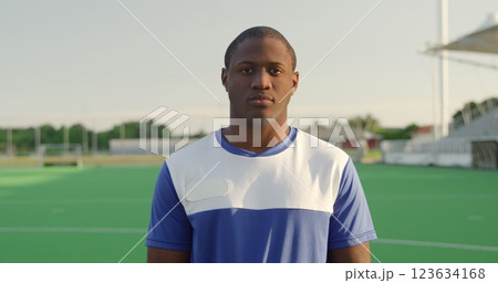 Portrait close up of an African American male field hockey player, wearing a blue team strip, standi Portrait close up of an African American male field hockey player, wearing a blue team strip, standi 123634168