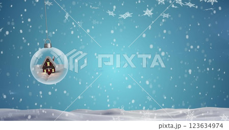 Image of falling snow over christmas ball and models Image of falling snow over christmas ball and models 123634974