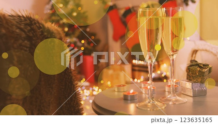 Image of yellow spots of light over new year glasses of champagne and christmas tree 123635165