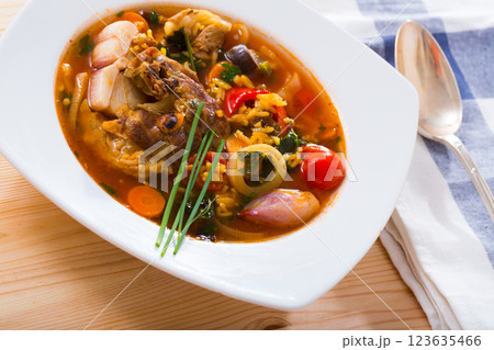 Soup of lamb with rice, vegetables, garlic and onion, served in bowl 123635466