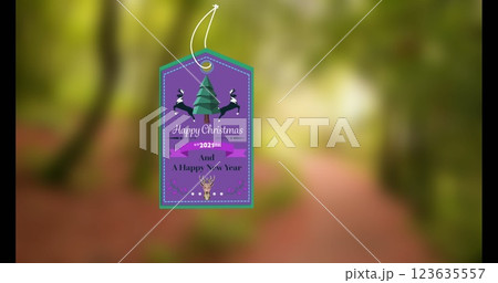 Image of gift tag with happy christmas text and icons over blurred background Image of gift tag with happy christmas text and icons over blurred background 123635557