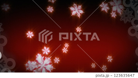 Image of glowing snowflakes falling against red background with copy space 123635647