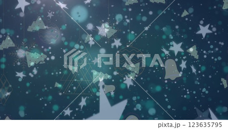 Image of christmas bell and stars icons over hanging christmas decorations on green background 123635795