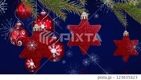 Image of christmas baubles decorations with snow falling 123635823