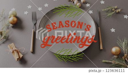 Image of christmas greetings text over christmas place setting Image of christmas greetings text over christmas place setting 123636111