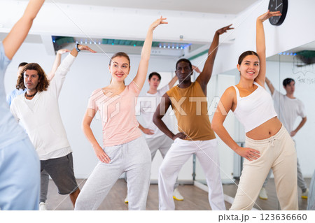 Group of different people rehearsing dance in dance studio Group of different people rehearsing dance in dance studio 123636660