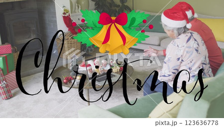 Image of christmas greetings text over caucasian senior couple on laptop image call at christmas Image of christmas greetings text over caucasian senior couple on laptop image call at christmas 123636778