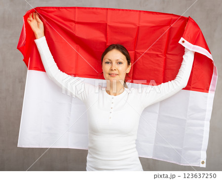 Attractive female football fan holding Poland flag Attractive female football fan holding Poland flag 123637250