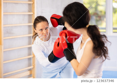 Two women training boxing fight in studio Two women training boxing fight in studio 123637346