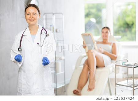 Adult female doctor posing in medical room 123637424