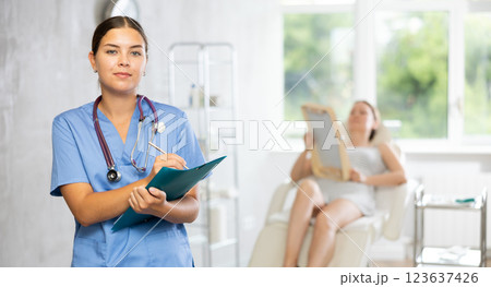 Young female doctor making notes in medical room Young female doctor making notes in medical room 123637426