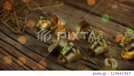 Image of christmas gold bells on rustic wooden background Image of christmas gold bells on rustic wooden background 123641567