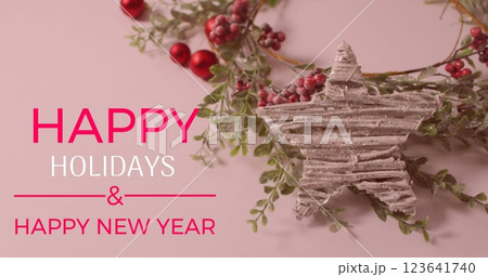 Image of happy holidays and text banner over red cherries and star decoration on pink surface Image of happy holidays and text banner over red cherries and star decoration on pink surface 123641740