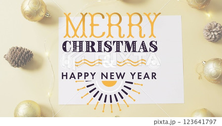 Image of merry christmas text banner against pinecone, bauble and fairy lights on pink surface 123641797