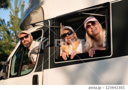 Family enjoying a scenic road trip in their camper van during a sunny afternoon in a beautiful natural setting Family enjoying a scenic road trip in their camper van during a sunny afternoon in a beautiful natural setting 123642301