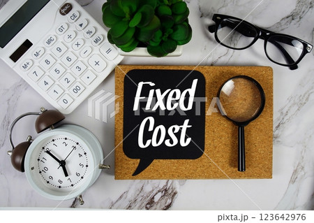 Fixed Cost text on speech bubble with alarm clock, calculator and magnifying glass on marble background Fixed Cost text on speech bubble with alarm clock, calculator and magnifying glass on marble background 123642976