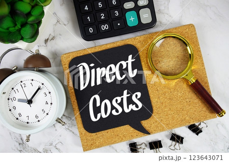 Direct Costs text on speech bubble with alarm clock, calculator and magnifying glass on marble background Direct Costs text on speech bubble with alarm clock, calculator and magnifying glass on marble background 123643071