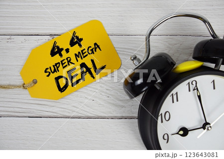 4.4 Super Mega Deals Promotion on price tag with alarm clock on wooden background 4.4 Super Mega Deals Promotion on price tag with alarm clock on wooden background 123643081
