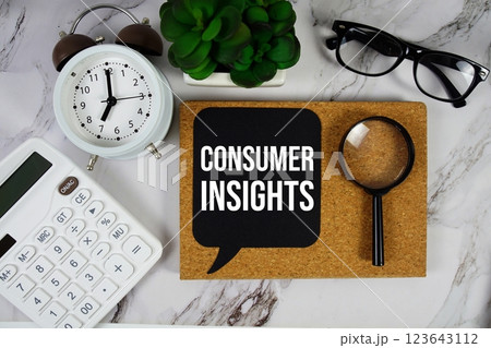 Consumer Insights text on speech bubble with alarm clock, calculator and magnifying glass on marble background Consumer Insights text on speech bubble with alarm clock, calculator and magnifying glass on marble background 123643112