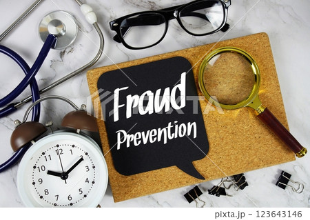 Fraud Prevention text on speech bubble with alarm clock, magnifying glass and stethoscope on marble background Fraud Prevention text on speech bubble with alarm clock, magnifying glass and stethoscope on marble background 123643146