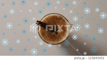 Image of snow falling over christmas drink and decorations 123643452
