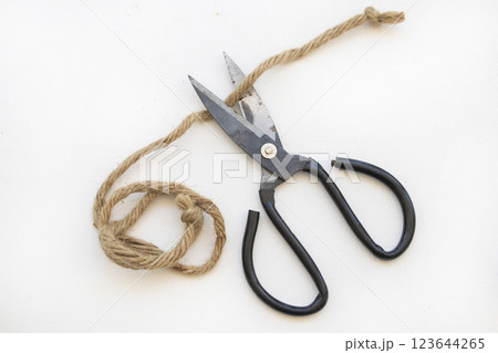 iron scissors with brown rope cutting arrangement flat lay style iron scissors with brown rope cutting arrangement flat lay style 123644265