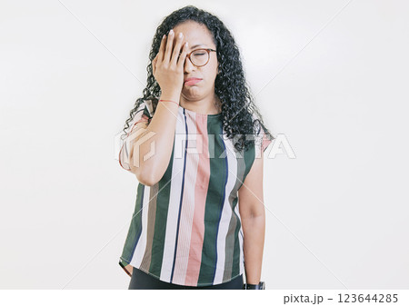 Worried young woman holding his forehead. Stressed young woman holding her forehead. Stressed people with palm on forehead isolated 123644285