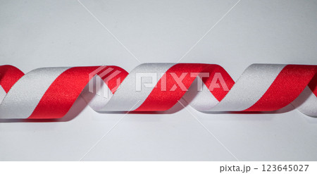 Red white flag ribbon, celebrate concept on white background Red white flag ribbon, celebrate concept on white background 123645027