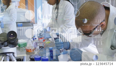 Image of financial data processing over diverse scientists working in lab 123645714