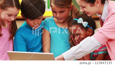 Image of diverse schoolchildren using laptop over school items icons 123647135