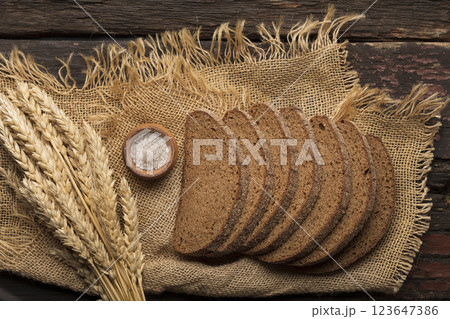 dark flour bread on a wooden table dark flour bread on a wooden table 123647386