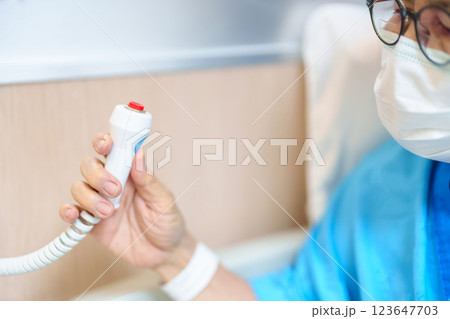 Elderly woman Patient hand holding and pressing emergency button in hospital room, calling nurse in emergency case. Professional Medical system and Safety Alert 123647703
