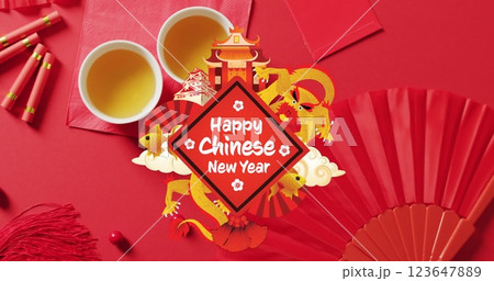 Image of new year greetings text over chinese traditional decorations on red background 123647889