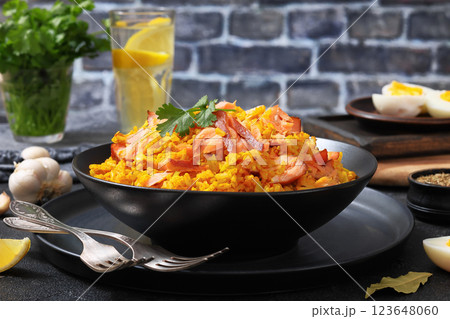 hot smoked salmon kedgeree in a black bowl hot smoked salmon kedgeree in a black bowl 123648060