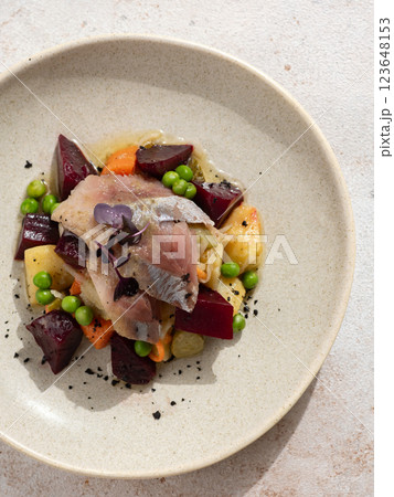 Restaurant dish with fish snack. Salted herring, potatoes, beets, carrots, green peas decorated microgreens. Pickled Herring Fish. Top view or flat lay 123648153