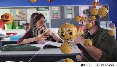 Image of emoji icons over diverse schoolgirl and teacher counting Image of emoji icons over diverse schoolgirl and teacher counting 123648398