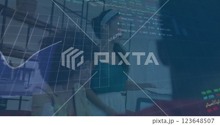 Image of financial data processing over diverse business people in office Image of financial data processing over diverse business people in office 123648507