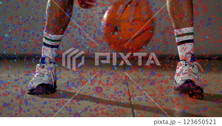 Dribbling basketball, person with spots image over legs Dribbling basketball, person with spots image over legs 123650521