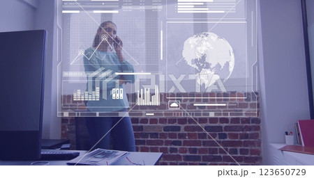 Image of financial data processing over biracial businesswoman in office Image of financial data processing over biracial businesswoman in office 123650729
